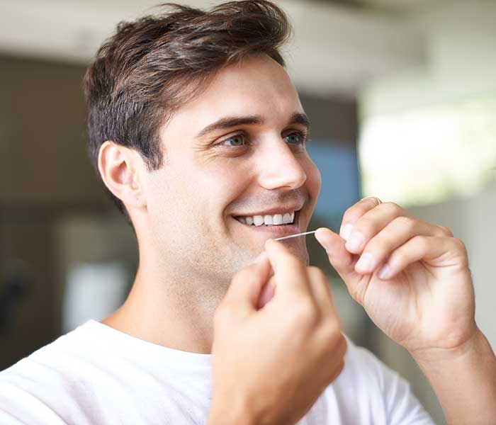 Closeup of a young Man flossing in Paradise Valley, AZ