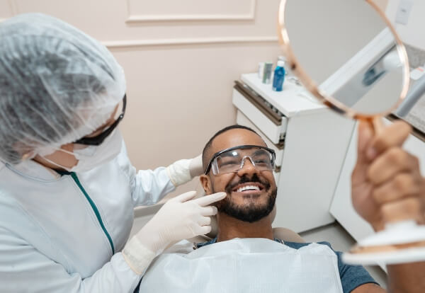 Smiling Patient after Wisdom tooth Extraction Recovery - S&L Dental