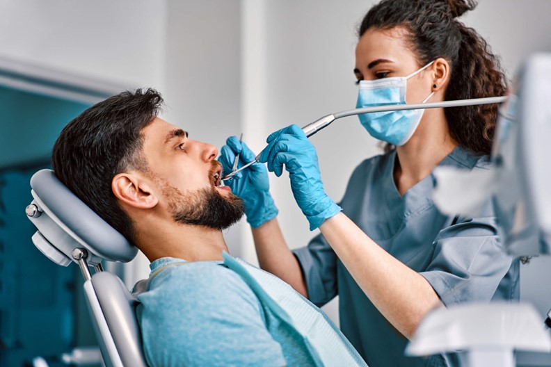 A dentist examining a patient's teeth