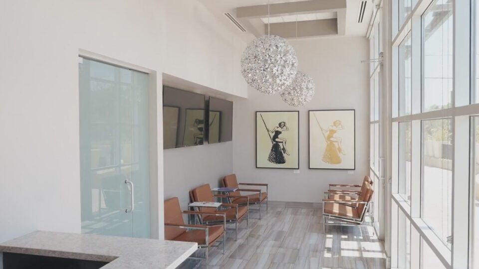 The waiting room at S&L Dental in Paradise Valley, with tan leather chairs and crystal pendant lights